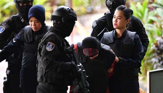 Indonesian national Siti Aisyah is escorted by Malaysian police for her trial at the Shah Alam High Court on Thursday.