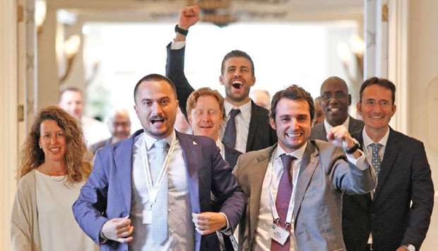 Tennis Director of the Kosmos sports group Ivan Modia (left) celebrates with team members, including founder and Barcelona footballer Gerard Pique (four right) after ITF approved a radical Davis Cup revamp in Orlando, Florida yesterday. (AFP)