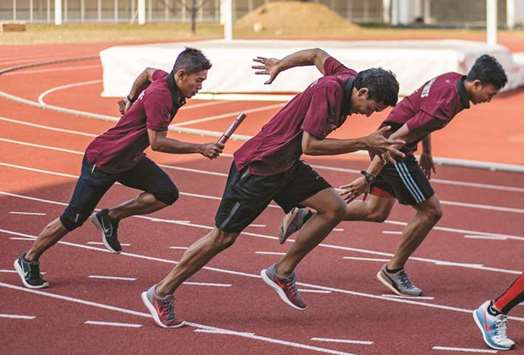In this July 27, 2018, picture, Indonesian sprinter Lalu Zohri (centre) takes part in a practice session with his teammates at the Senayan sport complex in Jakarta. (AFP)