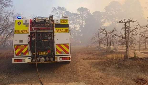 A fire engine is parked near a bushfire in New South Wales, Australia, earlier this week.