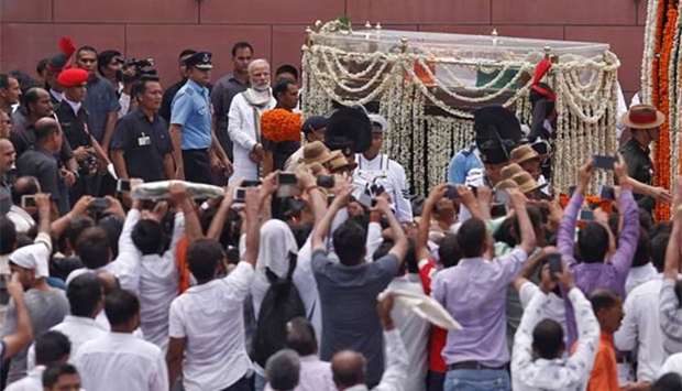 India's Prime Minister Narendra Modi pays homage to former prime minister Atal Bihari Vajpayee at the Bharatiya Janata Party headquarters in New Delhi on Friday.