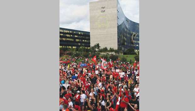 Lula supporters gather in front of the Electoral Supreme Court, as Lulau2019s face contour is projected on the building, where the Workersu2019 Party (PT) officially registered his unlikely presidential candidacy for the October 7 election.