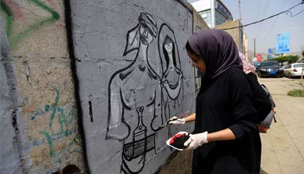 A Yemeni artist paints a pro-peace graffiti on a wall in Sanaa, as they call for peace and tolerance and rejecting the ongoing conflict in the Arab country.