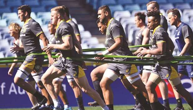 Australiau2019s players warm up during the teamu2019s Captainu2019s Run in Sydney yesterday, ahead of their Rugby Championship opener against New Zealand. (AFP)