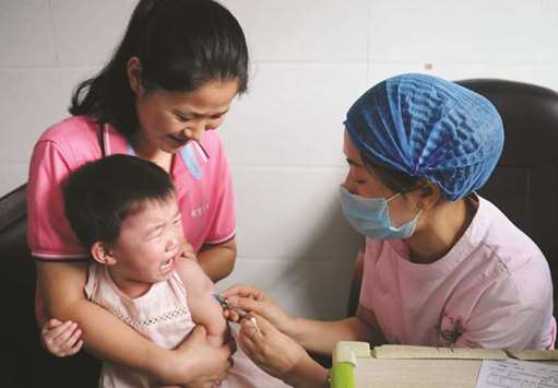 A child receiving a vaccination shot at the local disease control and prevention centre in Jiujiang in Chinau2019s central Jiangxi province.