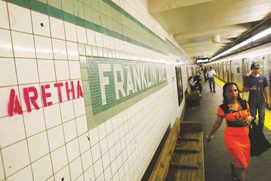 u2018Arethau2019 is spray-painted next to a sign at the Franklin Street subway station, in memory of singer Aretha Franklin, in the Brooklyn borough of New York.