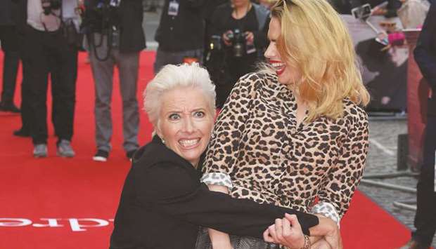 British actress Emma Thompson (left) grabs British-American actress Hayley Atwell on the red carpet as they arrive to attend the UK premiere of the film The Children Act in London on Thursday.