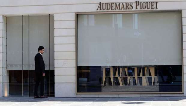 A man stands outside the the Swiss watchmaker Audemars Piguet shop in Paris following a robbery