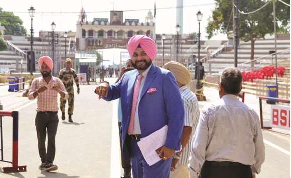 Navjot Singh Sidhu gestures as he arrives at the Wagah border on his way to Islamabad.