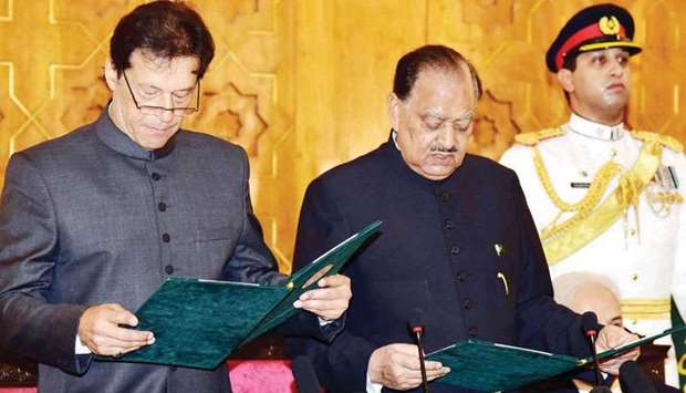 This photograph released by Pakistanu2019s Press Information Department (PID) yesterday shows President Mamnoon Hussain (centre) taking the oath of office from Imran Khan during the swearing-in ceremony in Islamabad. Also seen (partially concealed) is former chief justice of Pakistan Nasirul Mulk, who was the caretaker premier during the election period this year.