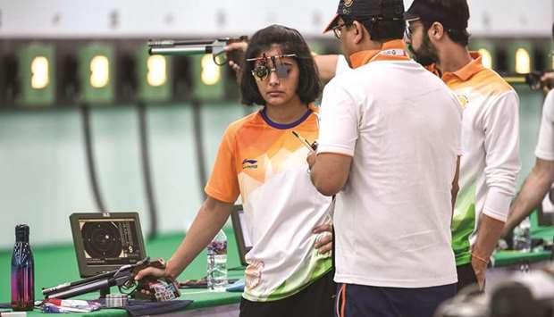 Indiau2019s Manu Bhaker (left) listens to her coach Jaspal Rana during a practice session for the mixed team 10m air pistol in Palembang, Indonesia, yesterday. (AFP)