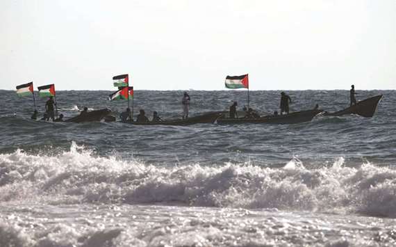 Palestinians ride boats during a protest against the Israeli blockade on Gaza yesterday.
