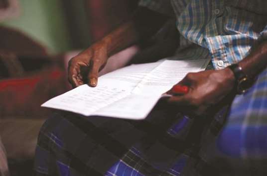 Ayub Salm holds the draft list of the National Register of Citizens (NRC) of his family in Dhubri district, in the northeastern state of Assam, India, August 2, 2018.