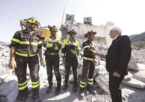 A handout photo made available by the Quirinal Press Office shows Italian President Mattarella during his visit to the site of the highway-bridge-collapse disaster, before attending the state funeral of the victims, in Genoa.