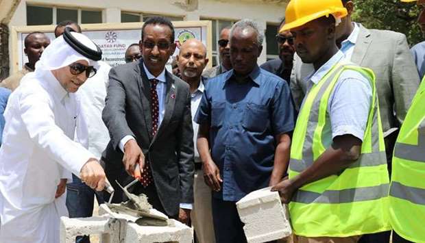 Somalia's Minister of Foreign Affairs Ahmed Eissa Awad (Second left) and Qatar ambassador Hassan bin Hamza Hashim (L) places the cornerstone of the project.