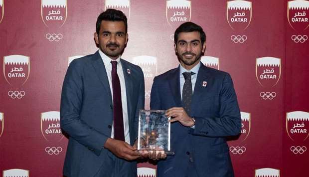 Qatar Olympic Committee (QOC) President HE Sheikh Joaan bin Hamad al-Thani and Aspetaru2019s representative Hussain Sultan al-Jaber pose with the 6th Sheikh Fahad Hiroshima-Asia Sports Medicine and Science Award.