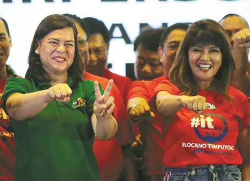 Davao City Mayor Sara Duterte-Carpio (left) and Ilocos Norte Governor Imee Marcos gesture during an alliance meeting with local political parties in Paranaque, Metro Manila.