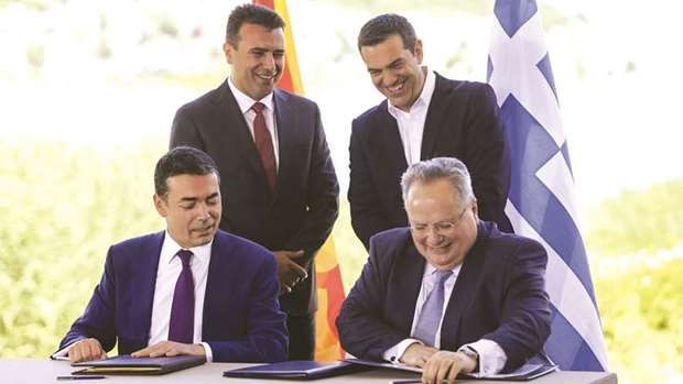 Greek Prime Minister Alexis Tsipras (back right) and Macedonian Prime Minister Zoran Zaev (back left) during the signing ceremony on June 17.