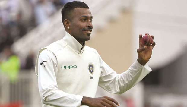 Indiau2019s Hardik Pandya walks off with the ball after taking five wickets on the second day of the third Test against England at Trent Bridge in Nottingham yesterday. (AFP)