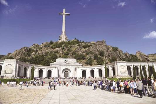 In this file photo taken on July 15, people wait to enter the basilica at the Valley of the Fallen in San Lorenzo del Escorial near Madrid. Francisco Franco, who ruled Spain with an iron fist from the end of the 1936-39 civil war until his death in 1975, is buried in the imposing basilica carved into a mountain-face just outside Madrid.