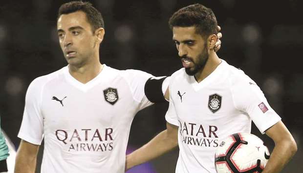 Al Saddu2019s Hassan al-Haydous (right) celebrates with captain Xavi after scoring a penalty against Al Gharafa in QNB Stars League yesterday.