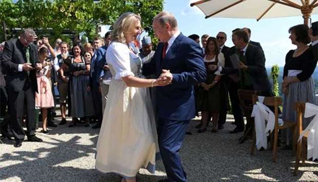 Austria's Foreign Minister Karin Kneissl dances with Russia's President Vladimir Putin at her wedding in Gamlitz, Austria, on Saturday.