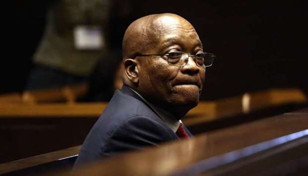 Former South African president Jacob Zuma stands in the dock of the High Court of Pietermaritzburg during his hearing over 16 corruption charges on July 27, 2018.
