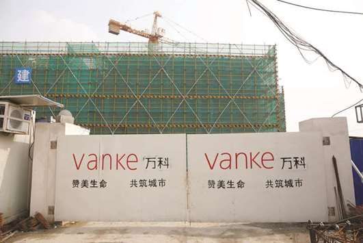Sign of Vanke is seen at a gate of a construction site in Shanghai. Net earnings at Chinau2019s second-largest residential developer increased to 9.1bn yuan ($1.3bn) from 7.3bn yuan a year earlier, the company said in an exchange filing yesterday.