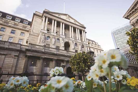 White primroses grow in a flower bed outside the Bank of England in London. A survey of 31 economists by Bloomberg shows the majority expect the benchmark rate to reach 1.25% by the end of 2019, a quarter-point higher than in the July survey.