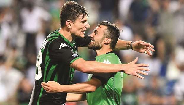 Sassuolou2019s Giangiacomo Magnani (left) embraces teammate Federico Di Francesco after their win over Inter Milan on Sunday night. (AFP)