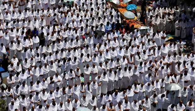 Muslim pilgrims pray outside Namira Mosque on the plains of Arafat on Monday