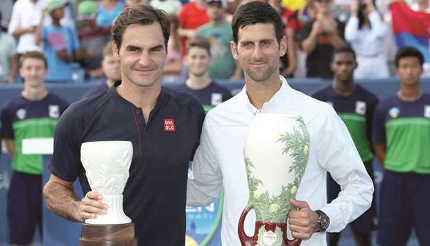 Champion Novak Djokovic (right) and runner-up Roger Federer pose with their trophies. (AFP)