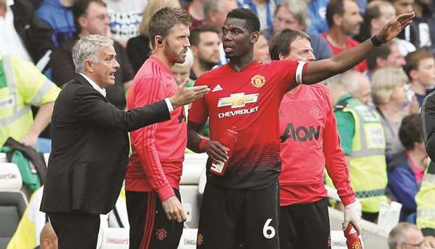 Manchester United manager Jose Mourinho (left) gives instructions to Paul Pogba during their defeat to Brighton in the Premier League on Sunday. (Reuters)