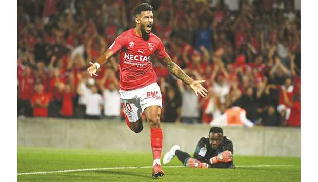 Nimesu2019 French midfielder Denis Bouanga celebrates after scoring against Marseille in the French Ligue 1 at the Costieres stadium in Nimes, southern France. (AFP)
