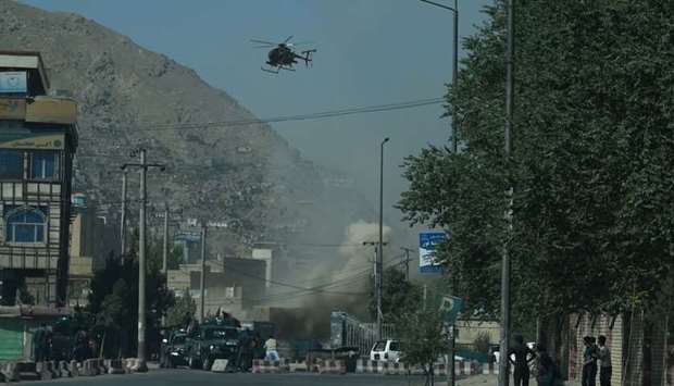 Smoke and dust (C) rise following an air strike from an Afghan military helicopter during ongoing clashes between Afghan security forces and militants near the Eid Gah Mosque in Kabul.