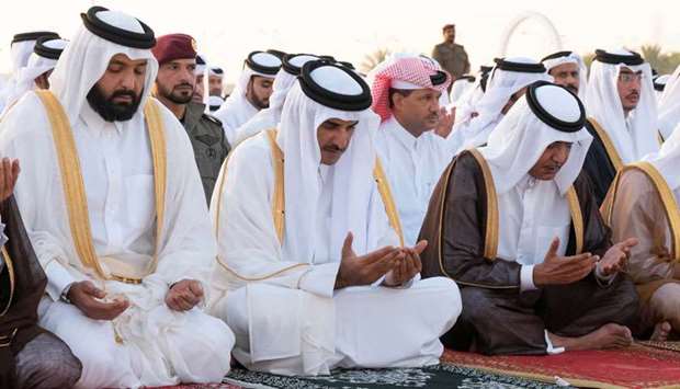 His Highness the Amir Sheikh Tamim bin Hamad al-Thani performs Eid al-Adha prayer at Al Wajba praying area on Tuesday.