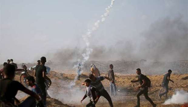 Palestinians react as tear gas is fired by Israeli troops during a protest at the Israel-Gaza border last month. File picture