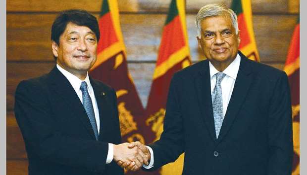 Japanese Defence Minister Itsunori Onodera (left) and Sri Lankan Prime Minister Ranil Wickremesinghe shake hands during a meeting in Colombo yesterday.