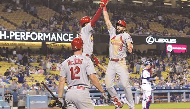 St. Louis Cardinals first baseman Matt Carpenter (right) celebrates with first baseman Jose Martinez and shortstop Paul DeJong (left) after hitting a home run in the ninth inning against the Los Angeles Dodgers. PICTURE: USA TODAY Sports