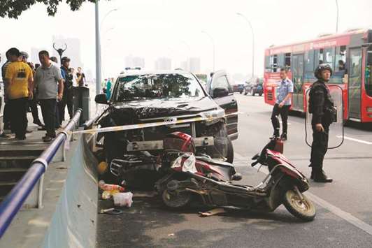 A damaged car after a crash in Liuzhou in Chinau2019s southern Guangxi region. The driver, who was escaping after killing his girlfriend and her family, crashed into motorbikes and then attacked passersby with a knife leaving two more people dead and 12 others injured, according to local police.