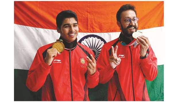 Gold medallist Saurabh Chaudhary (left) of India and bronze medallist Abhishek Verma pose with their medals after the menu2019s 10m Air Pistol podium in Palembang, Indonesia, yesterday. (Reuters)