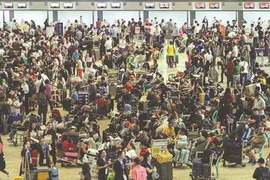 Passengers, including Overseas Filipino workers (OFWs), continue to wait for their respective flights at the Ninoy Aquino International Airport Terminal 1 in Paranaque, yesterday.