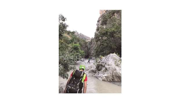 Rescue workers cross the canyon of the Raganello creek after several people were killed in a mountain gorge flooding.