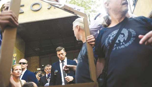 A demonstrator shows a mirror to Czech Prime Minister Andrej Babis as the latter gives a speech outside the Czech Radio building in Prague as part of the commemorations marking the 50th anniversary of the Soviet-led invasion of former Czechoslovakia in 1968.