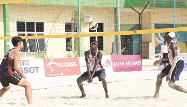 Qataru2019s Cherif Samba (centre) in action as teammate Ahmed Janko (right) looks on during the menu2019s beach volleyball Pool B match against South Korea at the 2018 Asian Games in Palembang yesterday.