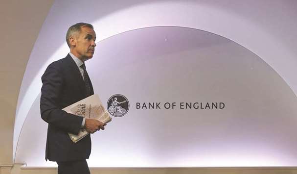 BoE governor, Mark Carney leaves after attending the central banku2019s quarterly Inflation Report press conference in London yesterday. The bank hiked interest rates by a quarter-point to 0.75% to help tame high inflation, and upgraded its 2019 economic growth forecast despite Brexit fears.