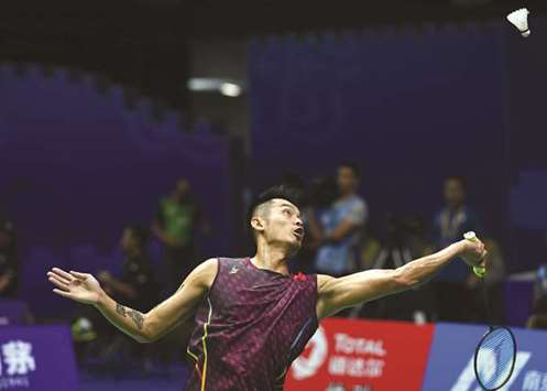 Chinau2019s Lin Dan hits a shot against compatriot Shi Yuqi during their badminton World Championships menu2019s singles match in Nanjing, China, yesterday. (AFP)