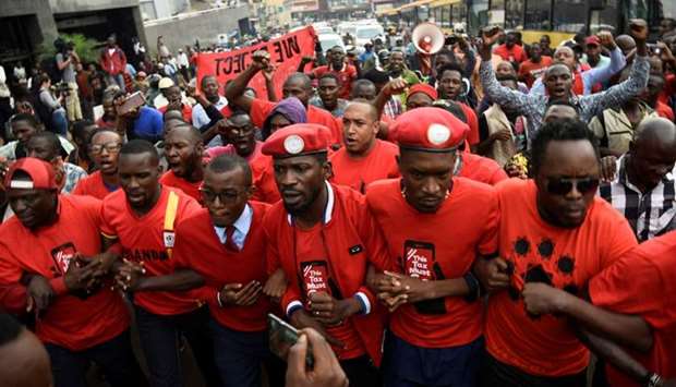 Robert Kyagulanyi (C) leads activists during a demonstration against new taxes including a levy on access to social media platforms in Kampala, Uganda on July 11, 2018.