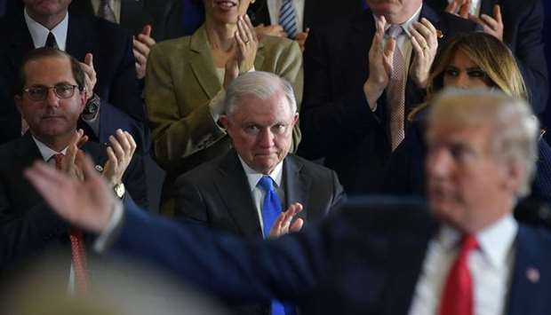 In this file photo taken on March 19, 2018 Attorney General Jeff Sessions (C) and First Lady Melania Trump (R) applaud as US President Donald Trump speaks about combating the opioid crisis at Manchester Community College in Manchester, New Hampshire