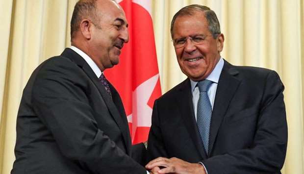 Russian Foreign Minister Sergei Lavrov (R) shakes hands with his Turkish counterpart Mevlut Cavusoglu at the end of their joint press conference following their meeting in Moscow.